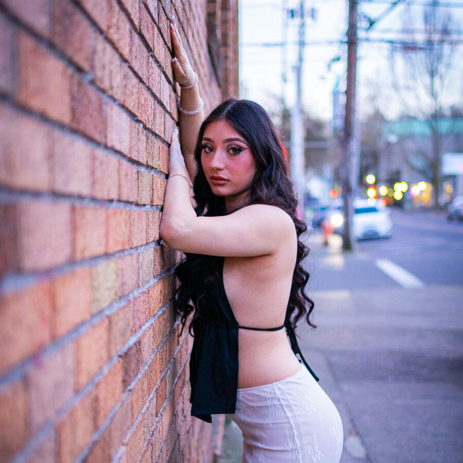 Model posing on a brick wall